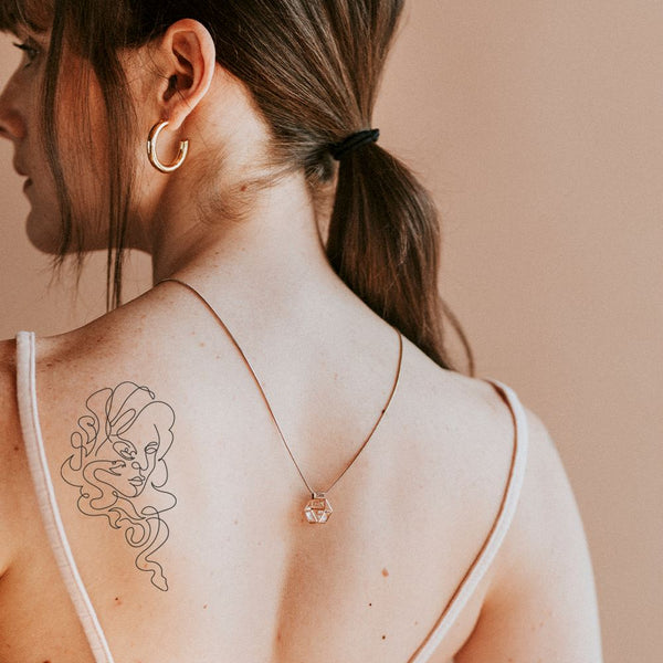 Sketch work medusa tattoo on the right shoulder blade.